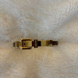 Michael Kors tortoise and gold bangle bracelt. Approx. 7 inches in diameter